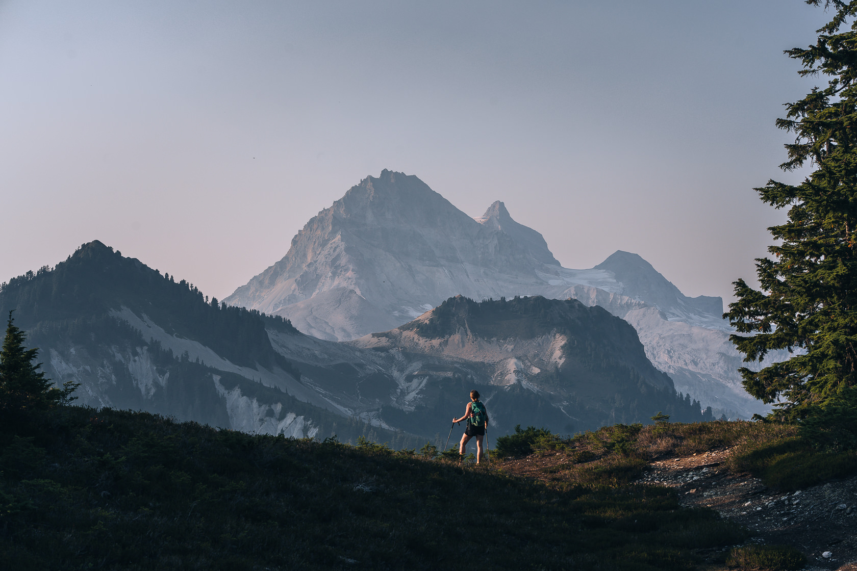 female hiker looking at Mt Garibaldi and Attwell peak from the Elfin lakes trail