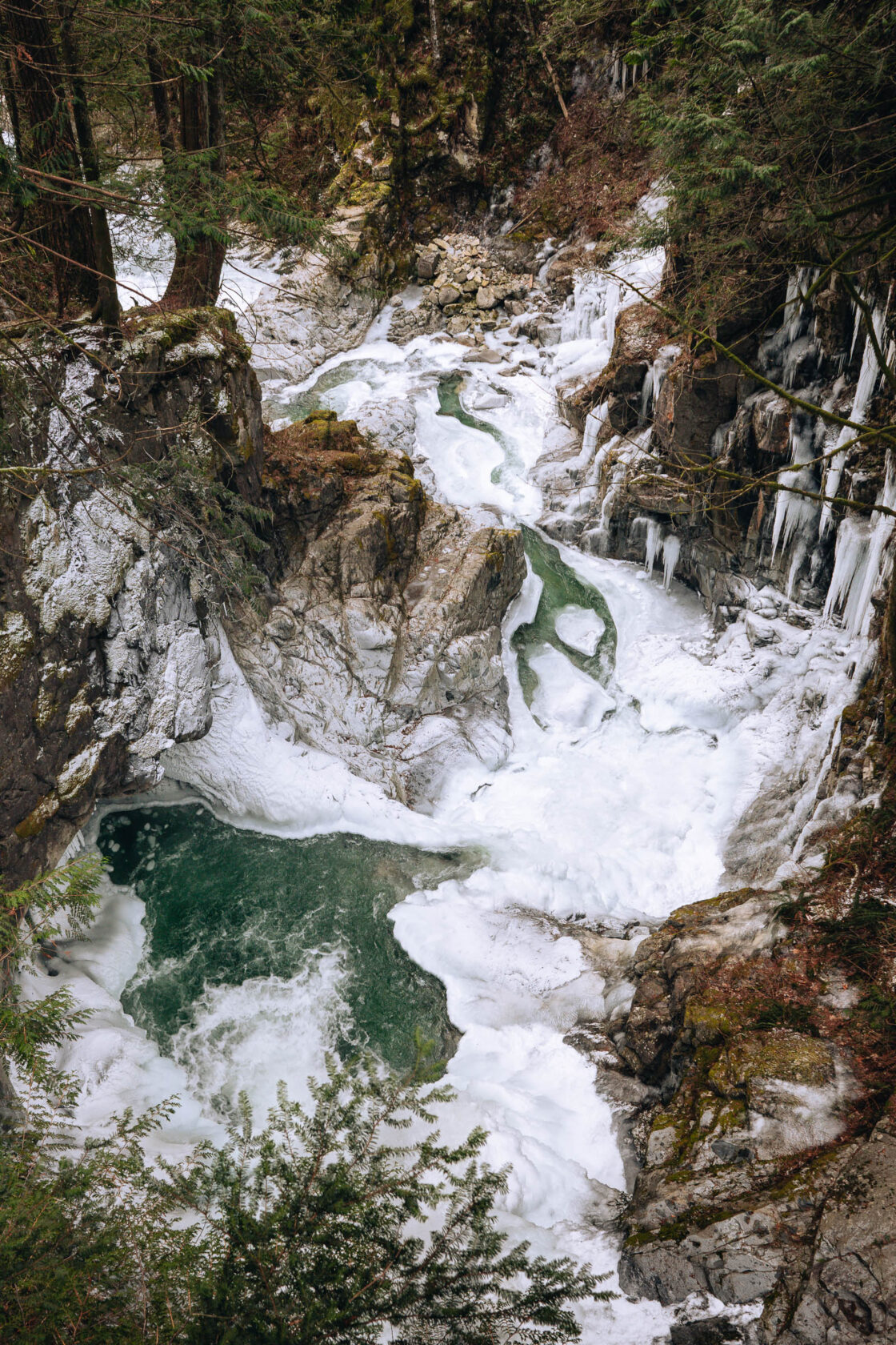 view on the other side of the suspension bridge where the water drops into a ravine