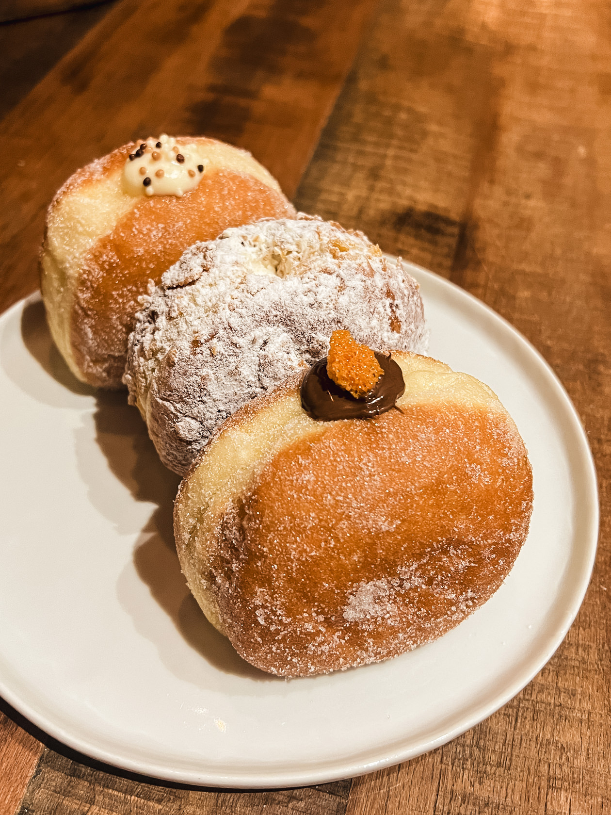 three Mello doughnuts on a plate