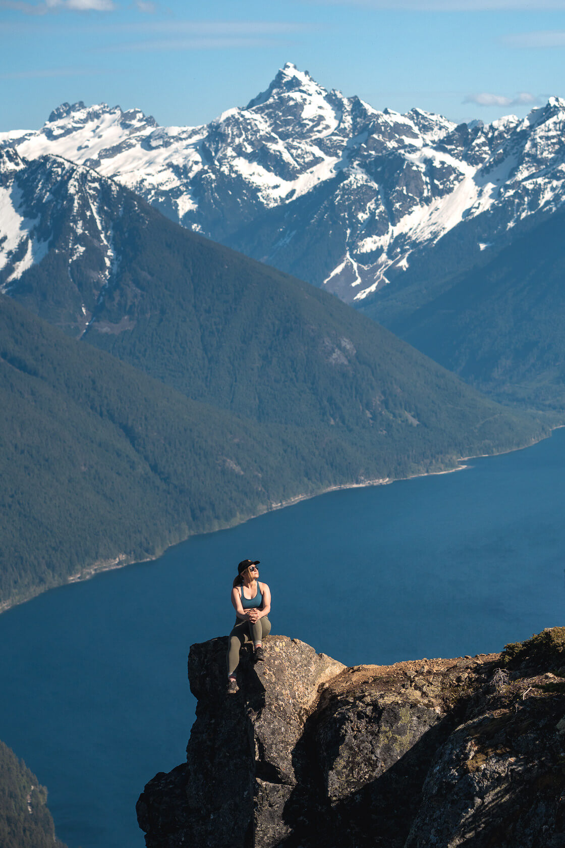 Hiker sitting on top of the Goat Ridge in Chilliwack