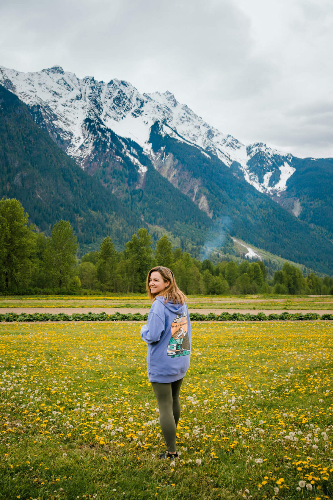 Female in a yellow field with Mount Currie in the background