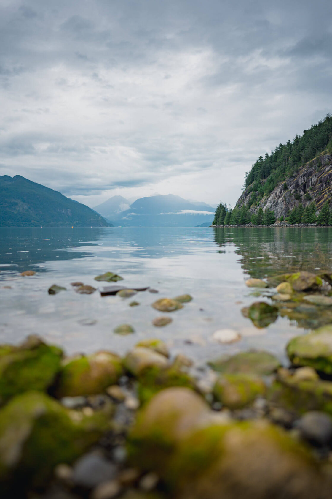 Porteau Cove view from low angle towards Howe Sound and the mountains in the background