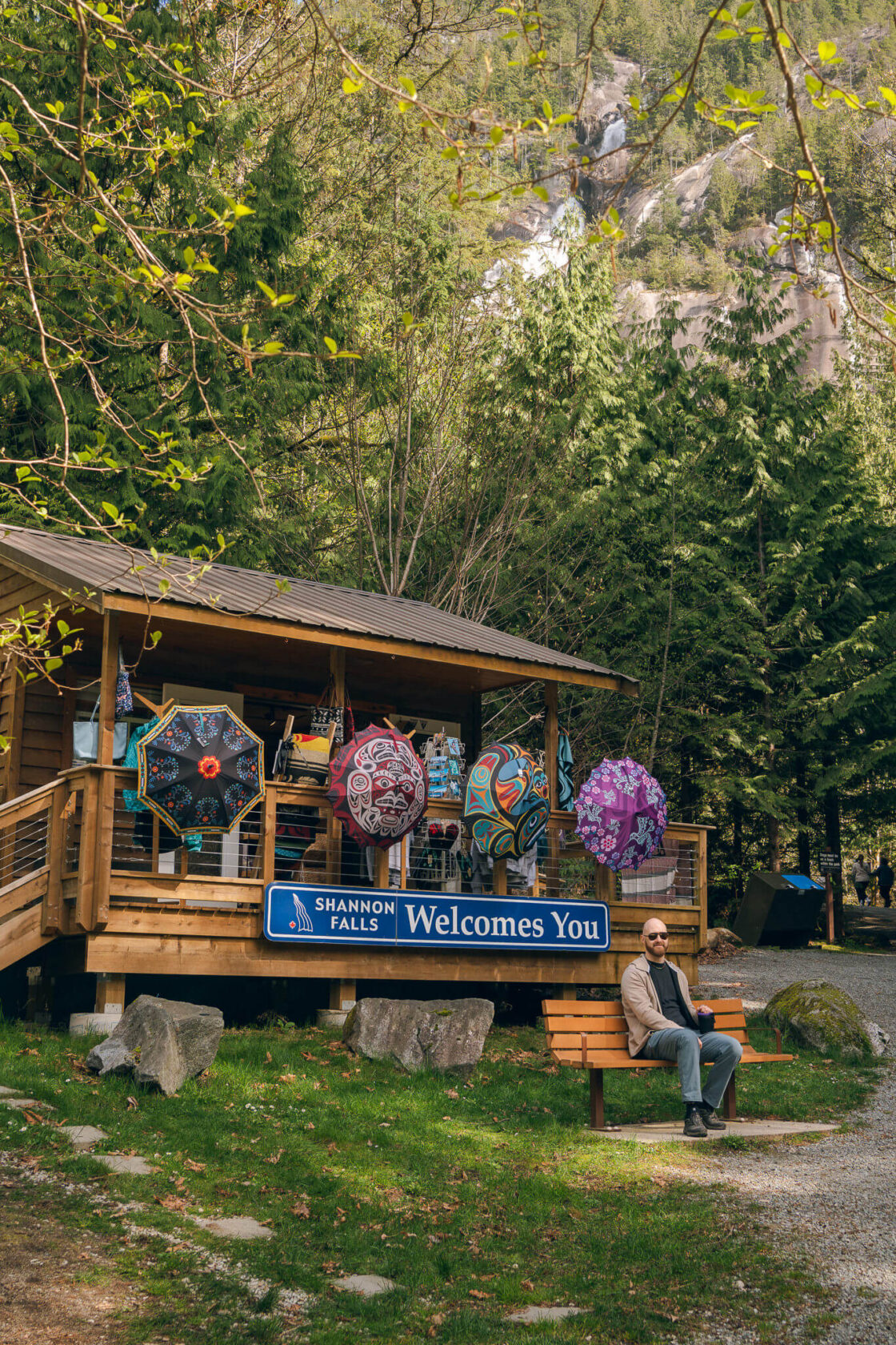 Shannon Falls welcome centre wooden building with umbrellas hanging outside and a welcome sign