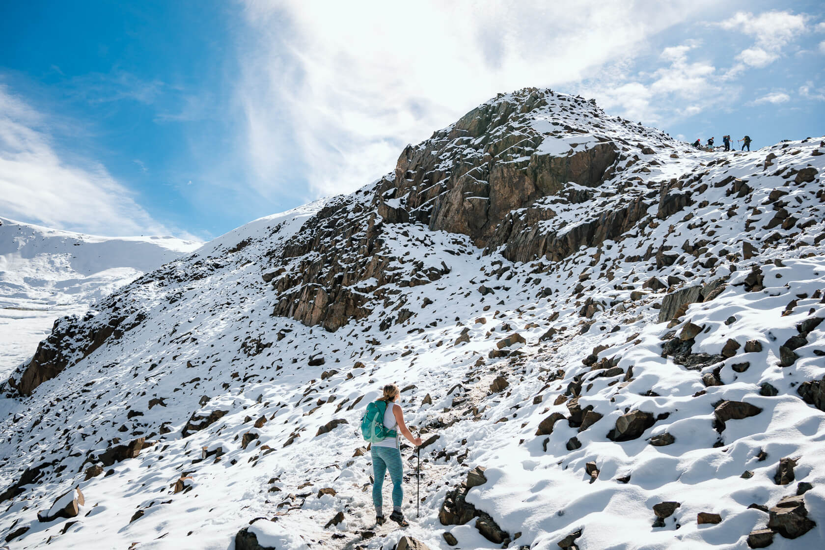 hiker on a snow-covered Panorama Ridge trail in October