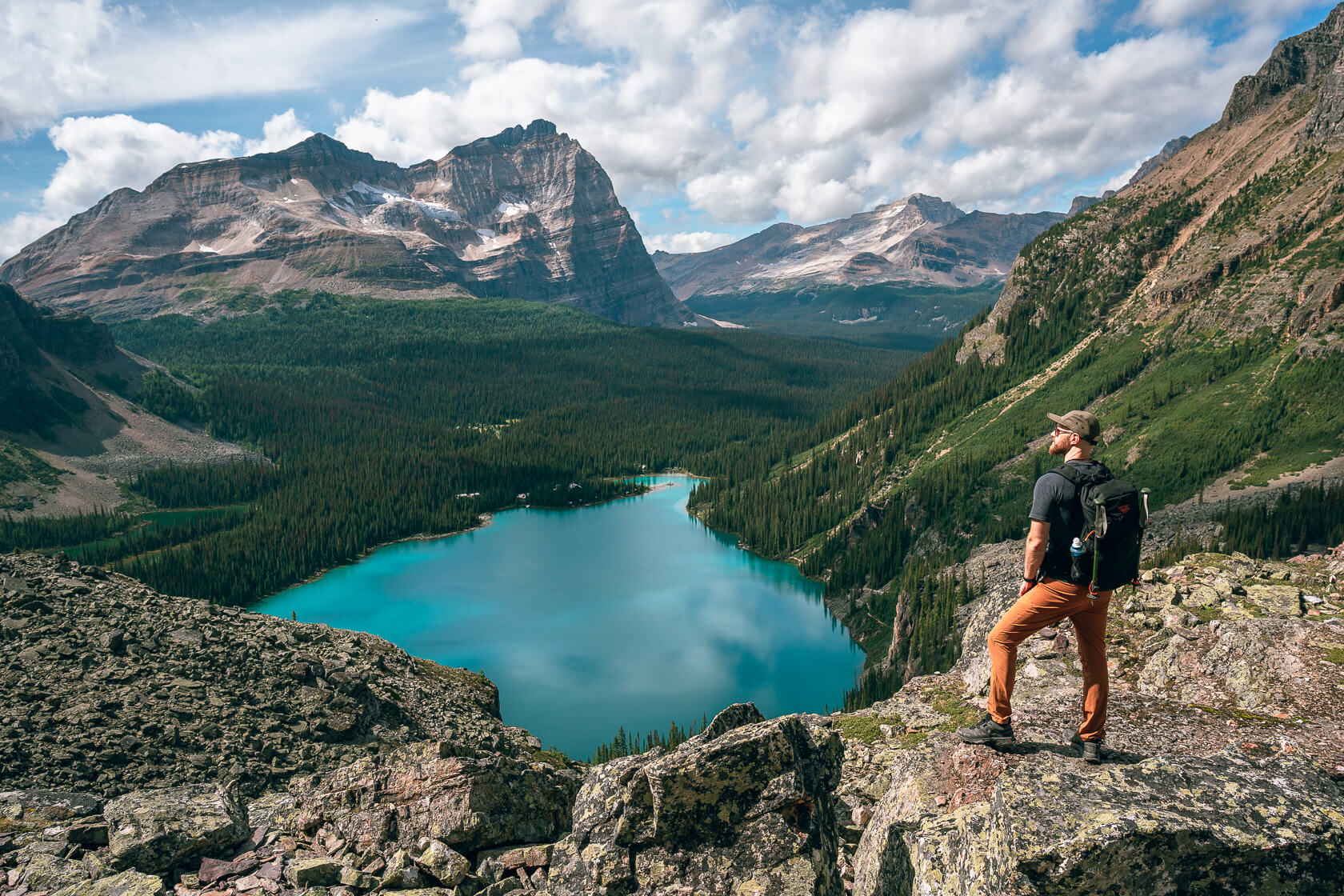 Hiker looking down at Lake O'Hara from a higher viewpoint